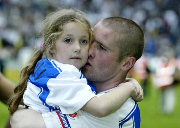 Halifax Town captain, Steve Bushell, is hugged by his daughter, Bethany, 8, after the final whistle of the Conference play-off game at Leicester on Saturday.  Town lost the game against Hereford 3-2.