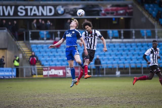 Jordan Burrow jumps for the ball with Josh Gowling during FC Halifax Town's 4-2 win over Grimsby at The Shay.