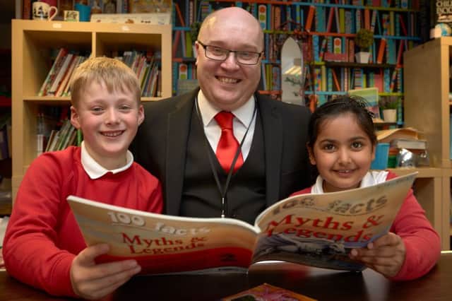 All Saints' CE School, Halifax has been nationally recognised for its exceptional 2015 performance. Head teacher Sinom Scott with pupils Ralphie Scott aged six and Mshira Shakeel aged six.