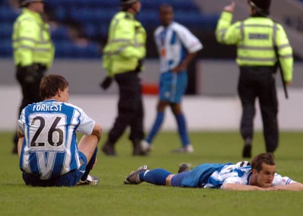 Dejected Halifax Town players Danny Forrest and Chris Senior after the final whistle. Picture: Gerard Binks.