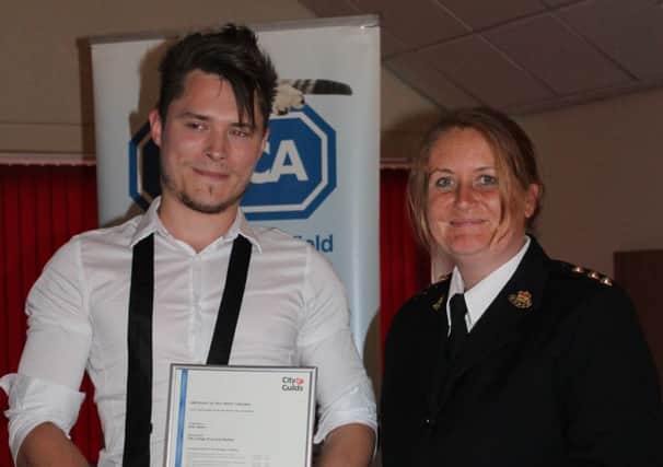 Sean Hearn receives his NVQ from RSPCA chief inspector Beth Clements.
