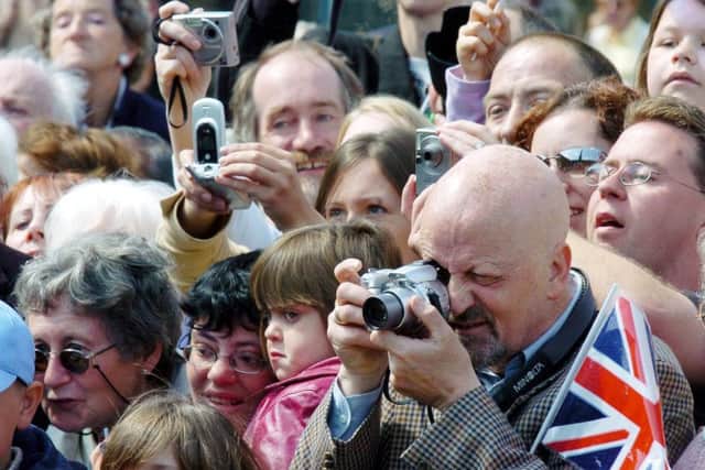 People scramble to photograph Her Majesty the Queen during her visit to the Piece hall, Halifax.