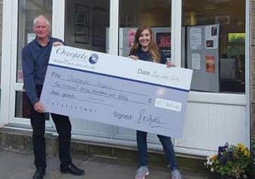 Craig Johnson, former Chairman of Ripponden Parish Council presenting a cheque to Faye Henderson from Overgate Hospice.