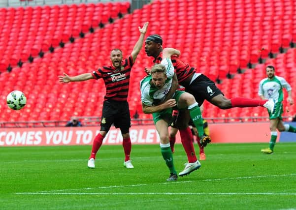 FA Trophy Final at Wembley Stadium.
North Ferriby United v Wrexham.
Ferriby's Danny Hone looks to be held by Wrexham's Manny Smith.
29th March 2015.
Picture Jonathan Gawthorpe.