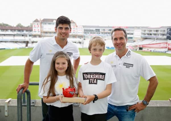 LONDON, ENGLAND - JUNE 23:  Alastair Cook of England and Michael Vaughan present the winners their trophy, Ruby Beaumont aged 10 from Halifax and Fred Teasdale, 10 from London during the final of Yorkshire Tea Young Cricket Commentator of the Year Finals at The Kia Oval on June 23, 2016 in London, England.  (Photo by Tom Shaw/Getty Images)