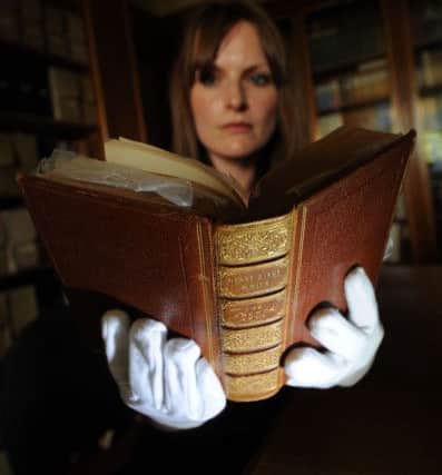 Libary and Collections Officer Sarah Laycock looks at the annotated copy of Robert Southeys 'The Remains of Henry Kirke.' Picture by Simon Hulme.