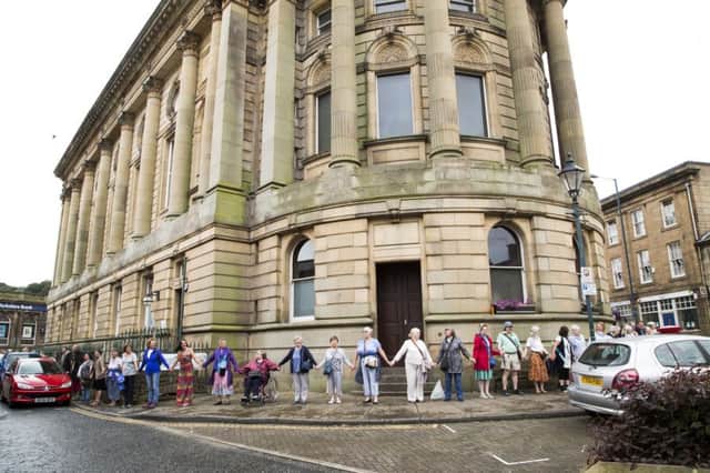 People join hands around Todmorden town hall in a show of solidarity against racism.