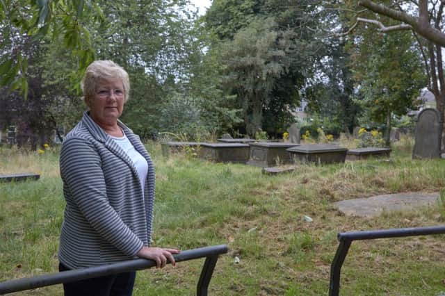Lesley Patrick is outraged at the state of St Martin's Church, Brighouse graveyard and the grass overgrown.