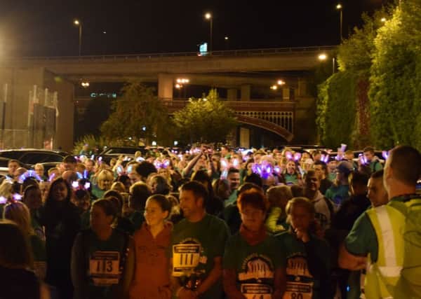 Walkers lined up in their green t-shirts to start the night time walk