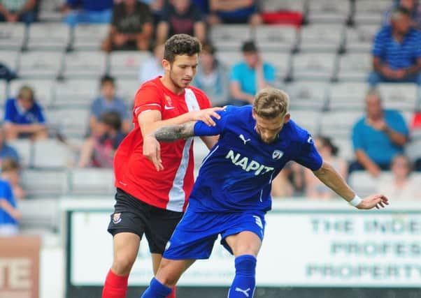 Halifax loanee Alex Simmons (left) in action for Lincoln