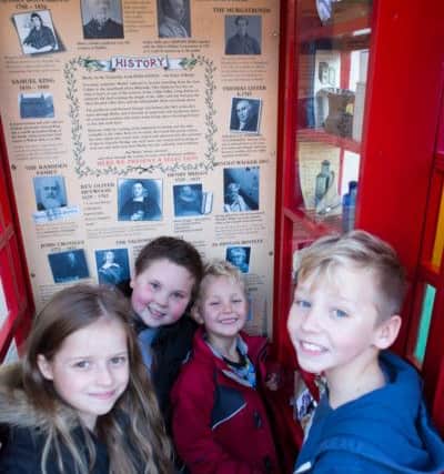 Opening of the Warley Village Museum, in an old phone box. Pictured are Arabella Howarth-Rogers, with Theo Szefer-Hall, Henry and George Szefer