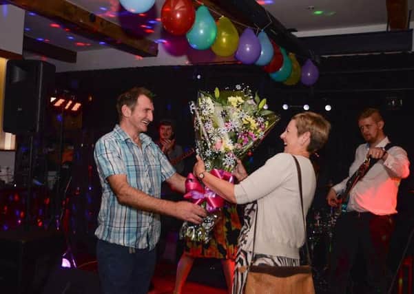 Jeremy's owner Rachel Bray receiving flowers for their birthday celebrations
