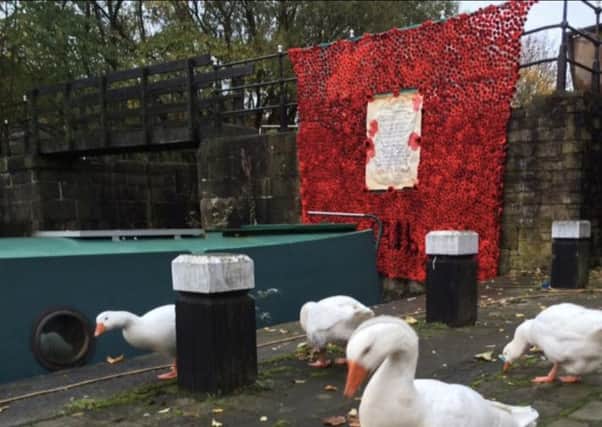 The poppy blanket hanging on the lock gate at the canal wharf, just by the Cobblestone's restaurant