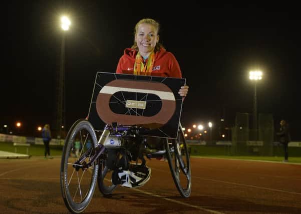 Paralympic, World and European champion Hannah Cockroft presents Leeds Athletics Club with commemorative piece of London 2012 track.  1 December 2016.  Picture Bruce Rollinson