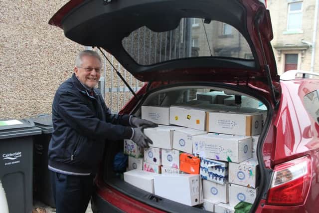 Rotarian Wilson Simms. How many shoeboxes can you fit into a car? Answer 137! All being delivered to charities in Todmorden