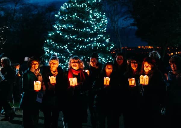 Lighting candles at Overgate Hospice