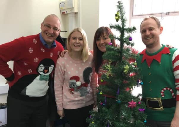 Our efforts in the Courier office. Can you do better than our Christmas sweaters?