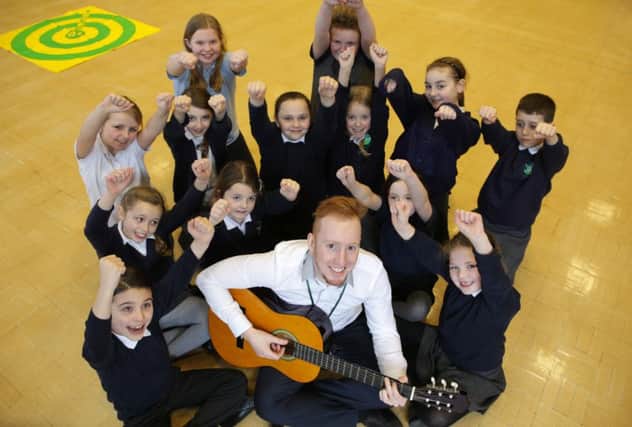 Teacher Scott Olgard with Withinfields Primary School, Southowram choir winners of the Halifax Courier Song For Christmas.