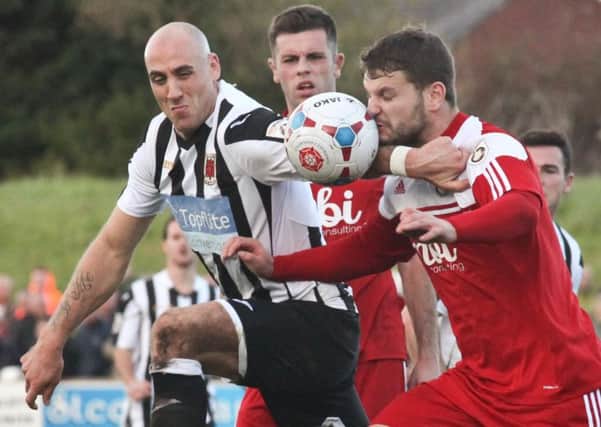 Chorley's  James Dean and Town's Simon Ainge challenge for the ball in their FA Cup meeting in October 2014.