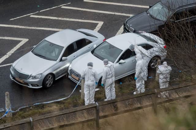 Date:3rd January 2017. Picture James Hardisty. Police incident on the Ainley Top slip road Huddersfield, West Yorkshire off the M62 junction 24 where one man has been shot dead by police, pictured West Yorkshire Police forensic teams examining the cars at the scene.
