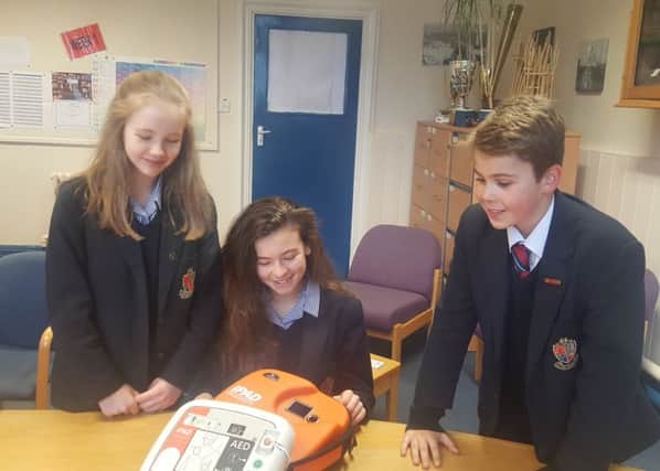 Students with their new defibrillators