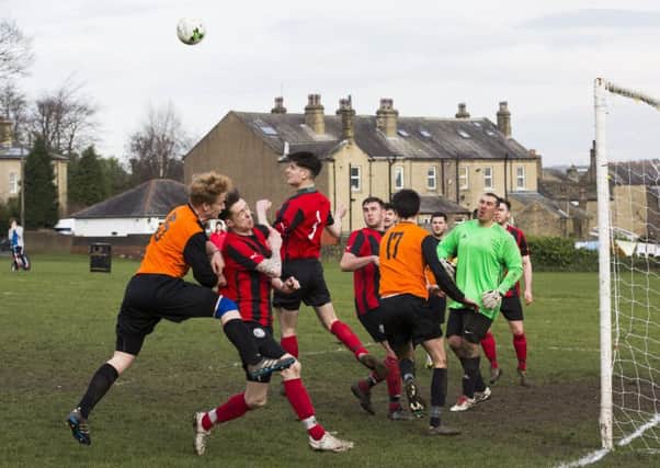 Football - Brighouse Sports v Warley Rangers. Warley's Jonny Lamb clears with his head.