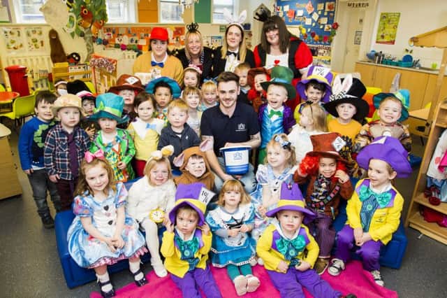 World Book Day - Mad Hatter's Tea Party themed fundraiser  for Sinead's Cancer Care at Bridge End House Day Nursery, Brighouse. Jamie Robson with staff and children.