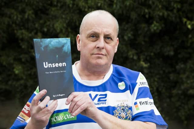Paul Farrell with the book that inspired him, Unseen by L A Rogers.