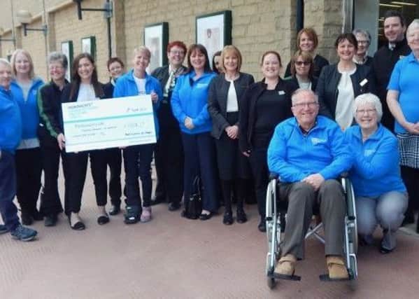 Staff from Marks and Spencer with members of the Parkinsons UK Halifax and District Branch at the cheque presentation