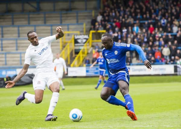 Cliff Moyo (right) is a doubt for Halifax's trip to Harrogate on Monday after he went off with a hamstring injury in the 1-0 defeat to Fylde at the Shay on Friday.