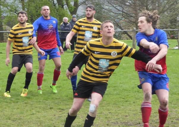 Beehive's Simon Gerrard tries to hold off Lee Mount's hat-trick man Callum Meade