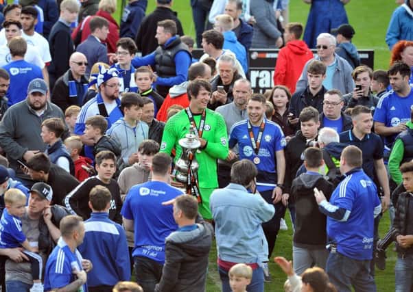 Jubilant keeper Sam Roberts with fans as Halifax celebrate promotion after winning 2-1 after extra time. Picture Tony Johnson.