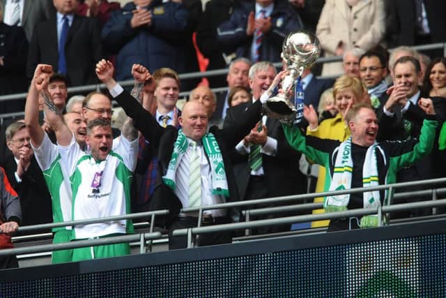 FA Trophy Final at Wembley Stadium.
North Ferriby United v Wrexham.
Ferriby's manager Billy Heath celebrates with the trophy.
29th March 2015.
Picture Jonathan Gawthorpe.