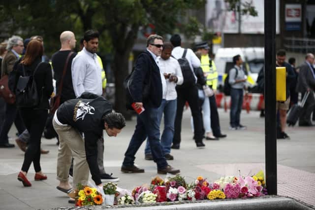 People lay flowers at the scene of the Borough Market and London Bridge terror attack that took place on Saturday night killing 7 people. 5 June 2017.