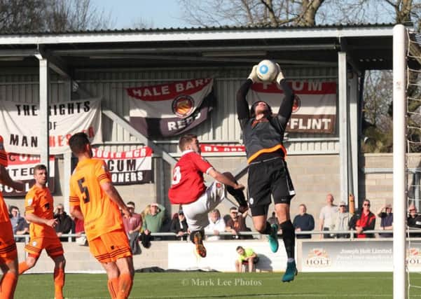 EYES ON THE BALL: Sam Johnson in action against FC United last season.                               Picture: Mark Lee