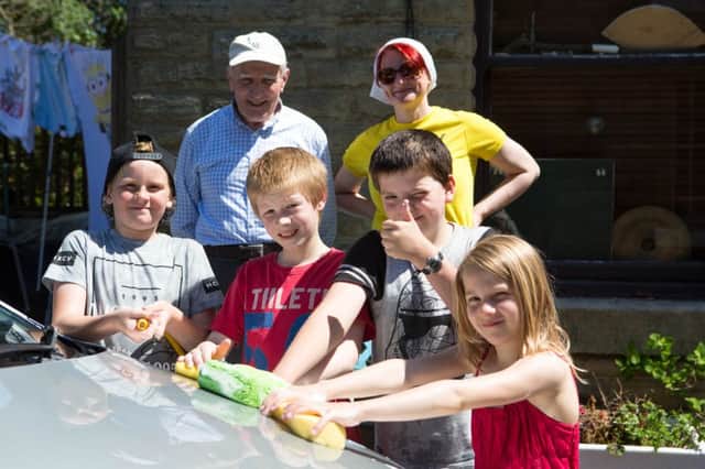 Jaspar Smith, with friends and family, doing a car wash in Cornholme, for the Fire Fighters Charity