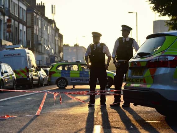 Police officers man a cordon in Finsbury Park, north London, after a van struck pedestrians. PA