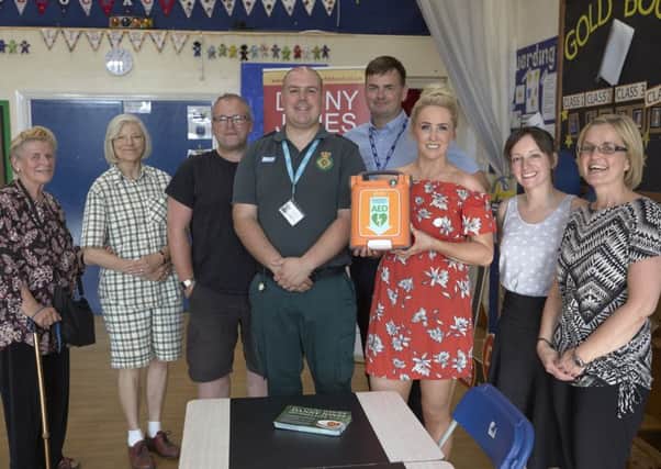Lizzie Jones with the new defibrillator at Salterlee Primary School, Shibden.