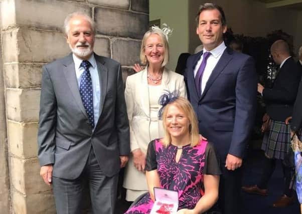 Karen with her family at the ceremony at Holyrood House, Edinburgh