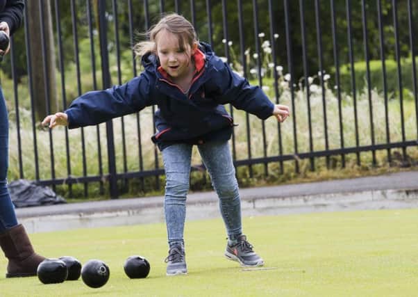 Imogen Walker, five, tries bowling at the Stainland Sports Association Junior Sports Mash-Up at Stainland Memorial Park