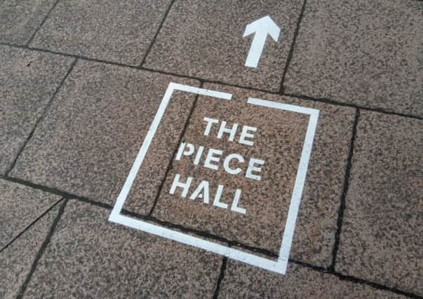 New pavement stencils point the way to the Piece Hall, Halifax, which re-opens on August 1