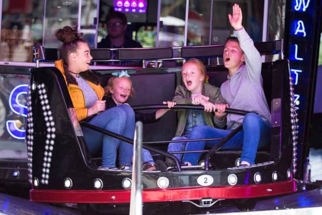 Reagan Stubbs, with Darcey, Brogan and Tylan Cartwright, on the Scream Machine, at Brighouse Summer Festival