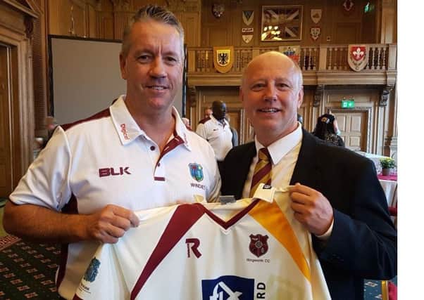 Former Illingworth CC player Stuart Law was presented with the Halifax League clubs latest shirt by vice-chairman Dorian Brooksby. Law is the West Indies coach and was attending a civic reception at Leeds Civic Hall prior to the second Test against England, starting today at Headingley. Law played for the Halifax club in the Aire/Wharfe League in 1990 prior to a professional career with Queensland, Essex and Lancashire as well as a Test for Australia against India.  Laws recent posts include spells as coach of Bangladesh, Sri Lanka and batting coach for Australia.