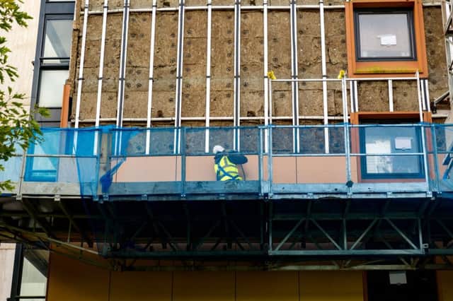 The cladding being removed on three blocks of flats in Mixenden, Halifax.