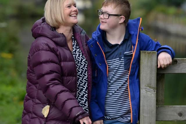 Jack Mawer, 13, walks his dog along the canal in Mytholmroyd with mother Mandy.