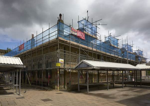 The wraps are about to come off the Â£500,000 refurbishment of Todmorden Market Hall, which has taken place through the summer and early autumn. Pictured is work under way in June.