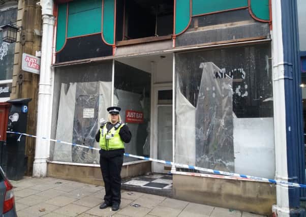 Police outside premises on Silver Street in Halifax town centre.