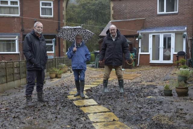 Floods in Burnley Road, Todmorden. Kendal Lindley with Cecelia and Phil Sunderland.