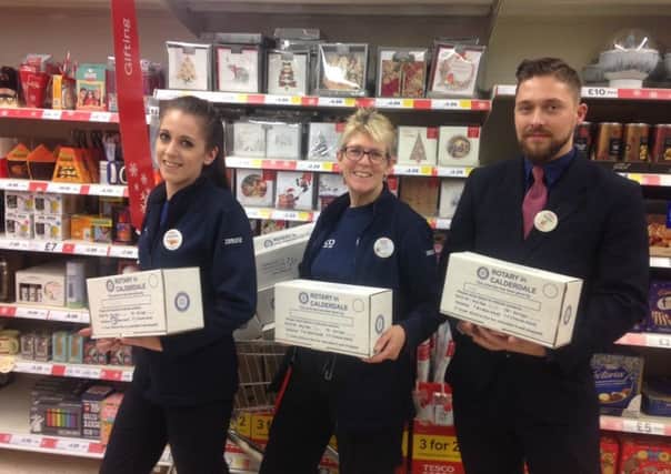 Community Champion Tracy Smith (middle flanked) with store managers Jordan Rimmer and Frances Sykes at Tesco in Brighouse