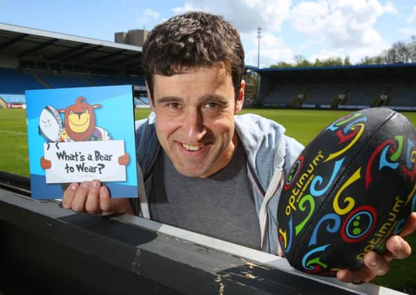 Author Tom Palmer at The Shay Stadium, Halifax, with one of his previous books.